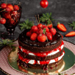 naked chocolate cake decorated with strawberries raspberry small apples and syrup